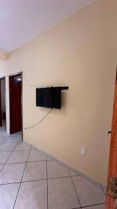 een muur met een flatscreen-tv aan een muur bij Casa Guriri in São Mateus