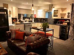 a living room with a couch and a table in a kitchen at Shropshire Guesthouse in Wolverhampton