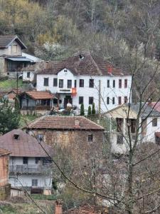 a large white house sitting on top of a hill at Villla Gezve in Velmevci +26 photos