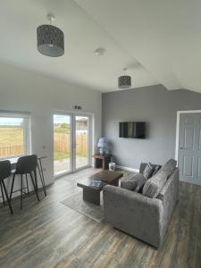 a living room with a couch and a table at 1 Lighthouse View in Lossiemouth