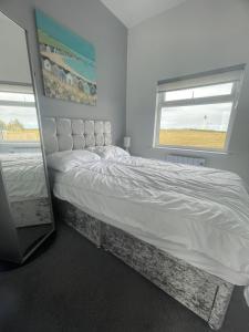 a bedroom with a bed and a window at 1 Lighthouse View in Lossiemouth
