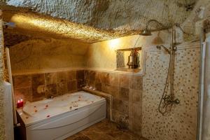 a bathroom with a bath tub and a shower at Keyf i ala capadocia in Ürgüp +63 photos