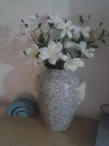 a blue and white vase with white flowers in it at Barud Gedera Israel in Gedera