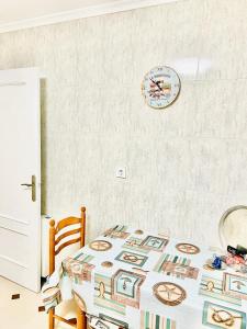 a bedroom with a table and a clock on the wall at Tineo centro in Tineo +8 photos