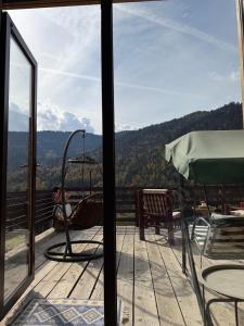 a balcony with a view of the mountains at Mitarbi Silence - cozy holiday cottages in mountains in Borjomi +49 photos