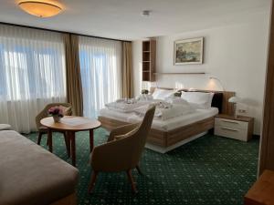 a hotel room with a bed and a table at Pension Seeblick in Seebruck