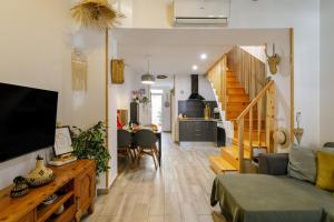 a living room with a couch and a dining room at Casita Santa Bárbara - Alicante in Alicante