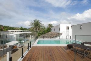 a view of a pool from the balcony of a house at Jubarte Flats in Itacaré