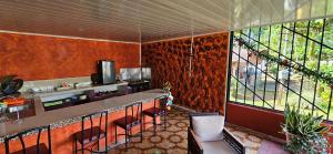 a kitchen with a counter and chairs in a room at Anita's Apartment in Upala