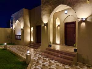 een gebouw met een deur en een veranda met verlichting bij Bab Al Shams Palace in Luxor