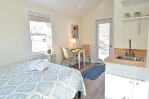 een keuken en een slaapkamer met een bed en een wastafel bij 4 Min Drive to Bayside Beaches in Eastham