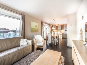 a living room with a couch and a table at Le Penthouse in Koksijde