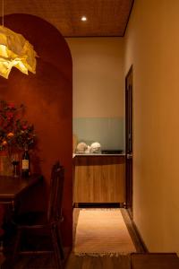 a kitchen with a counter and a table in a room at PINhome - PIN Boutique Stays in Ho Chi Minh City