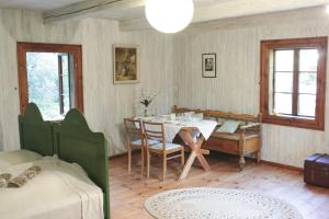 a dining room with a table and a table and chairs at Dom Poety in Kazimierz Dolny