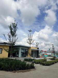 a building with trees in front of a playground at Kaizen Urban Retreat - Elevate Your Stay in Calo