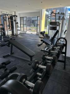a gym with a bunch of weights and machines at Kaizen Urban Retreat - Elevate Your Stay in Calo