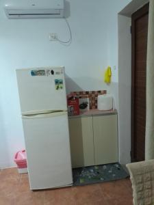 a kitchen with a white refrigerator and a counter at Tonia&Sion in Vlorë +58 photos