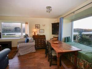 a living room with a wooden table and a window at Bryncyn in Newport