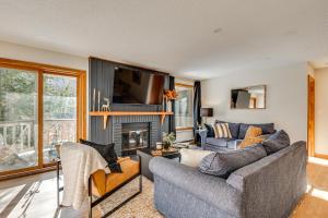 a living room with a couch and a fireplace at Riverfront Lincoln Condo w/ Patio + Pool Access! in Lincoln