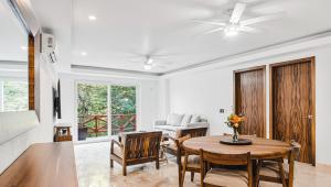 a living room with a table and chairs at Pájaro de Fuego 406 in Sayulita