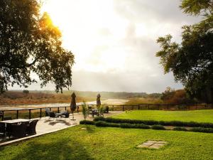 a view of a park with chairs and a lawn at Buckler's Africa Lodge Kruger Park in Komatipoort +40 photos