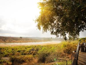 a river in the middle of a field at Buckler's Africa Lodge Kruger Park in Komatipoort