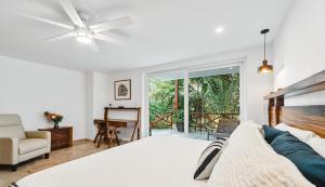 a bedroom with a bed and a couch and a window at Pájaro de Fuego 406 in Sayulita +10 photos