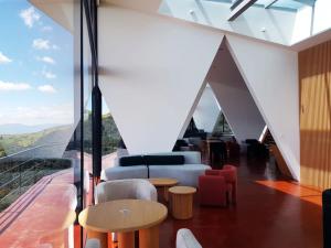 a living room with a view of the mountains at Ncielo Adventure Lodge in Quito