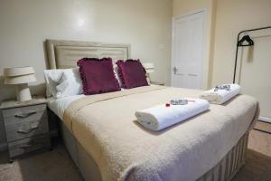 a bedroom with a large bed with towels on it at Victory House in Gretna
