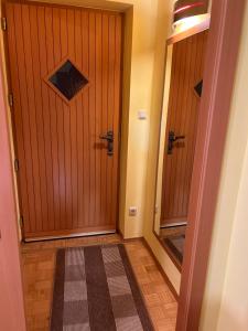 a hallway with two wooden doors and a rug at App in Gillersdorf