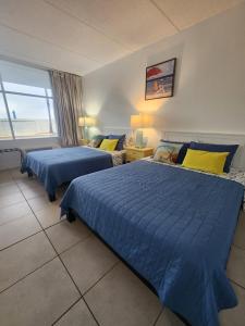 Ένα ή περισσότερα κρεβάτια σε δωμάτιο στο Harbor Haven Escape