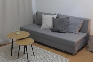 a living room with a couch and two tables at La Casa in Kozani