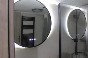 a mirror in a bathroom with a shower at La Casa in Kozani