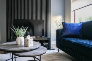 a living room with a blue couch and a table at Victory House in Gretna