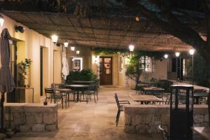 a patio with tables and chairs in a restaurant at Auberge du Rédier - Logis Hôtels in Colomars