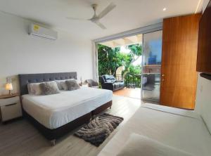 a bedroom with a bed and a sliding glass door at Anapoima Hills in Anapoima +42 photos
