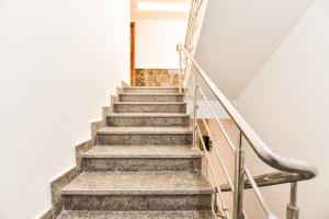 a set of stairs in a building at Capital O Maurya Inn in Banār