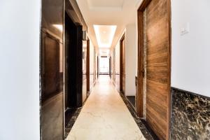 a corridor of a hotel with wooden walls and a long hallway at Capital O Maurya Inn in Banār