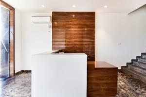 a staircase in a house with a white wall at Capital O Maurya Inn in Banār +32 photos