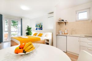 a bedroom with a bed and a bowl of fruit on a table at Guest House Kovacevic in Hvar