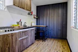 a kitchen with wooden cabinets and a counter top at Casa Vagon Isla Bendita in La Gonzalez