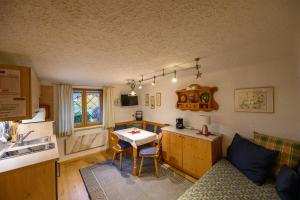 a kitchen with a couch and a table in a room at Ferienwohnungen Margreiter in Mitterbach