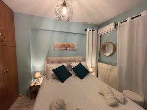 a bedroom with a large bed with two pillows at Kalavryta Moments in Kalavrita