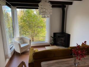 a living room with a couch and a chair and a fireplace at El Roble, casitas rurales in Valverde de la Vera
