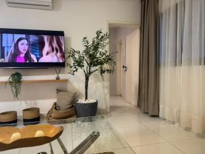 a living room with a flat screen tv on a wall at ORY luxury garden in Abidjan