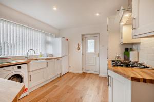 a kitchen with white cabinets and a dishwasher at 2 Bed in Snettisham oc-s28186 in Snettisham