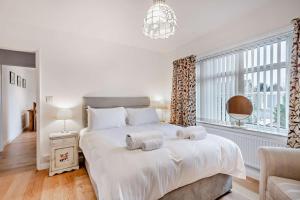 a bedroom with a large white bed with towels on it at 2 Bed in Snettisham oc-s28186 in Snettisham