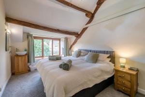 a bedroom with a large bed and a window at 4 Bed in Malham oc-c32684 in Airton