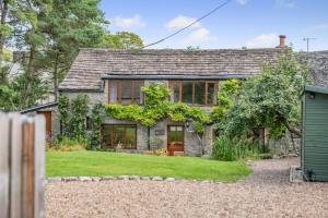 a stone house with a garden in front of it at 4 Bed in Malham oc-c32684 in Airton