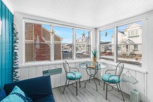 a screened in porch with a table and two chairs at Blue Chill in Hampton +37 photos